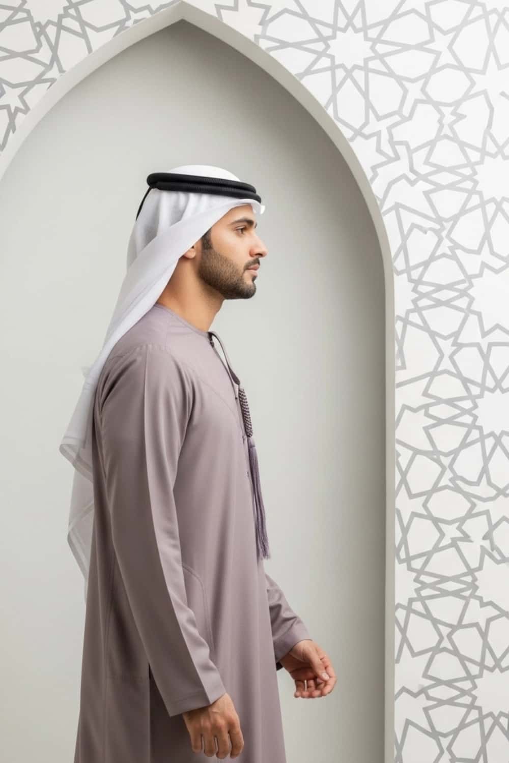 A man wearing the unique and sophisticated Warm Plum Kandura. 4