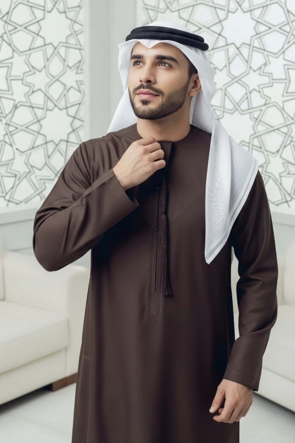 A man wearing the rich Dark Chocolate Winter Emirati Kandura. 2