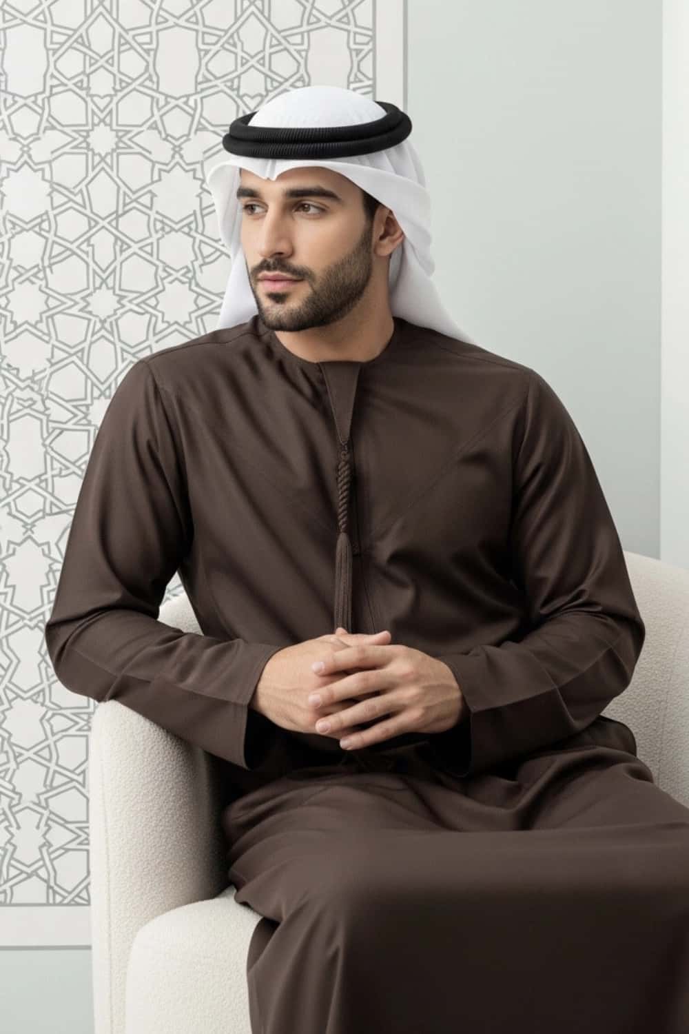 A man wearing the rich Dark Chocolate Winter Emirati Kandura. 3