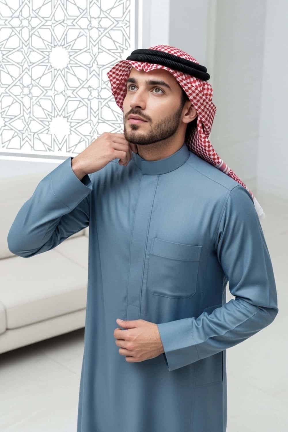 A man wearing the calm and confident Powder Blue Saudi Thobe. 2