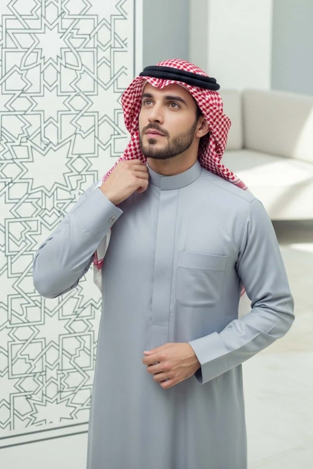 A man wearing the cool and sharp Ice Grey Saudi Thobe. 3