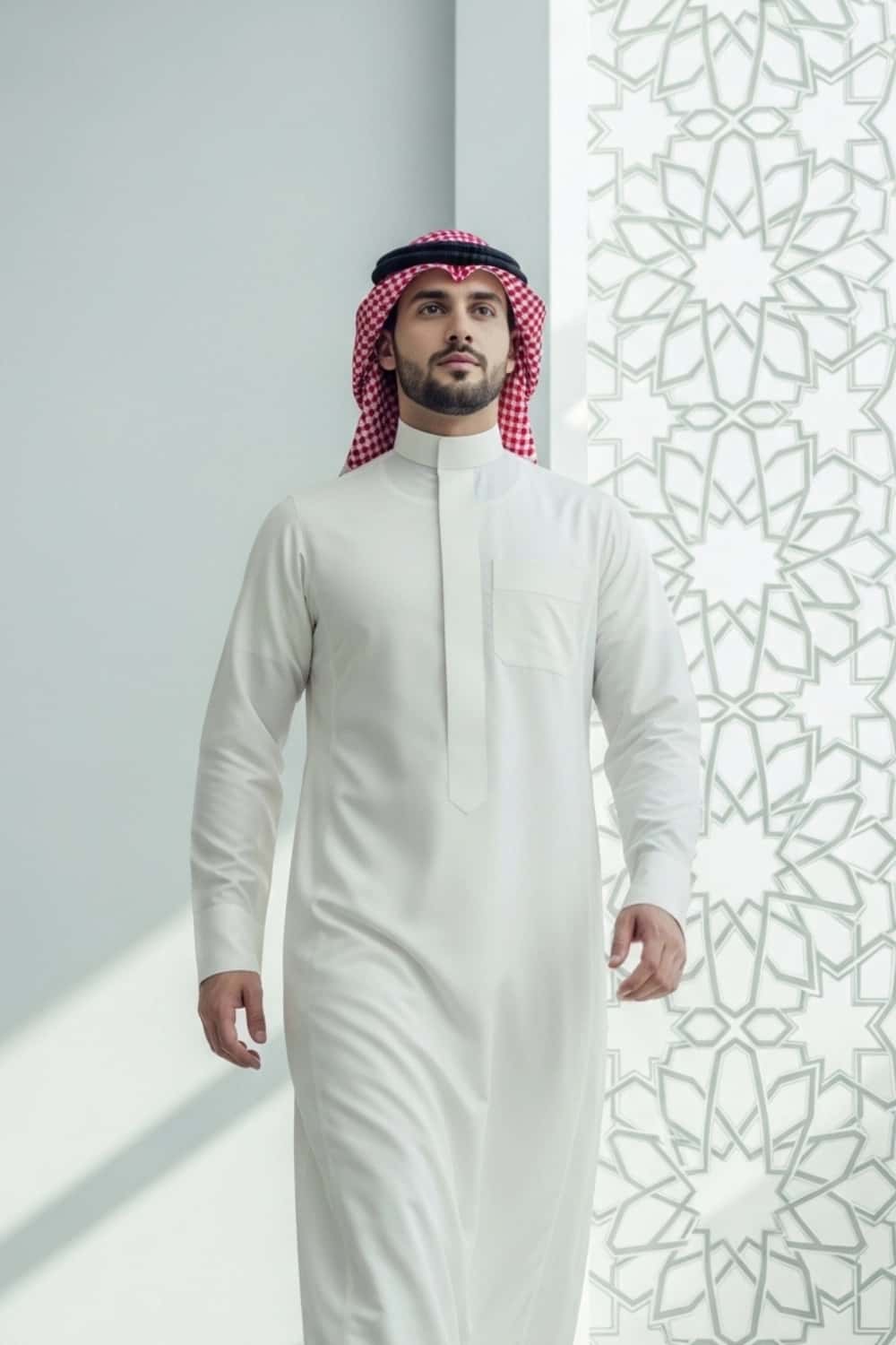 A man wearing the elegant and clean Cream Saudi Thobe. 4