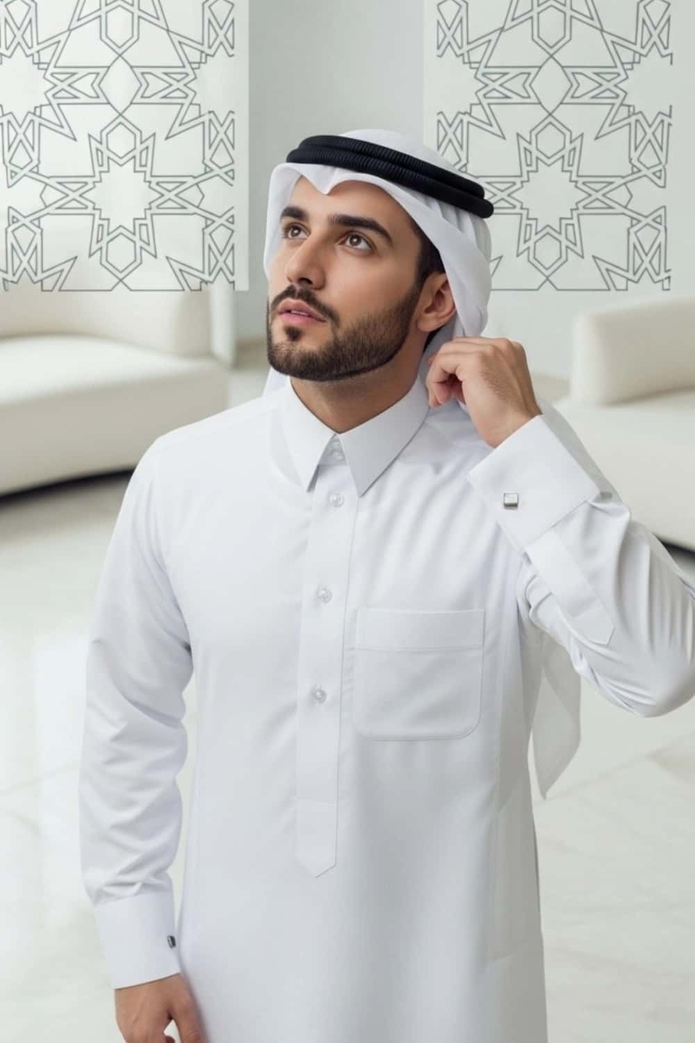 A man wearing the pristine White Qatari Thobe from the Elite Edition. 3