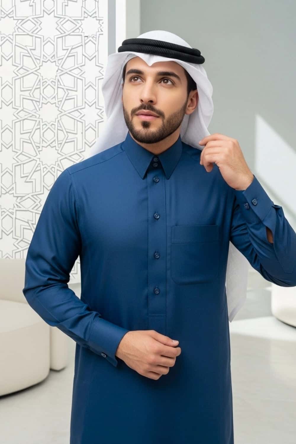 A man wearing the distinct Blue Qatari Thobe from the Stellar Edition. 3