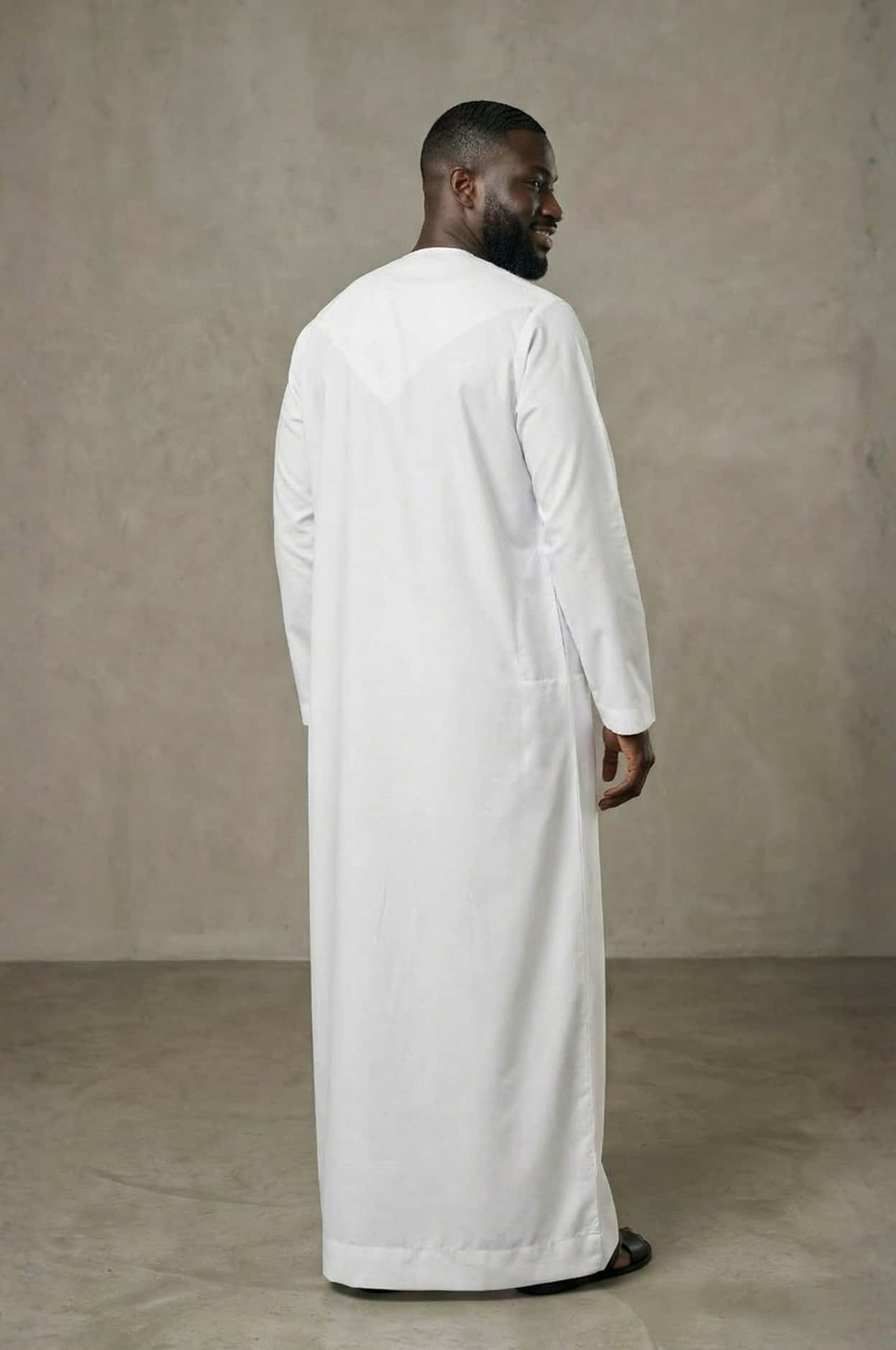 Sophisticated international businessman wearing a crisp white premium kandora in a luxury Abu Dhabi setting, exuding confidence and elegance. 4