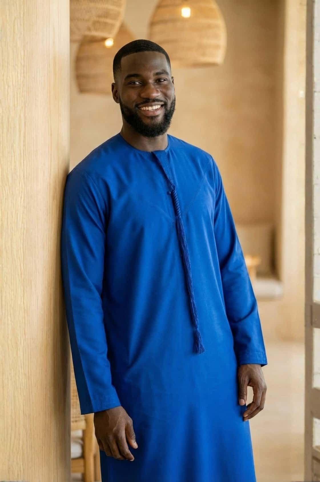 Distinguished gentleman wearing a royal blue kandora at a luxury Abu Dhabi venue, embodying regal elegance in traditional dress. 3