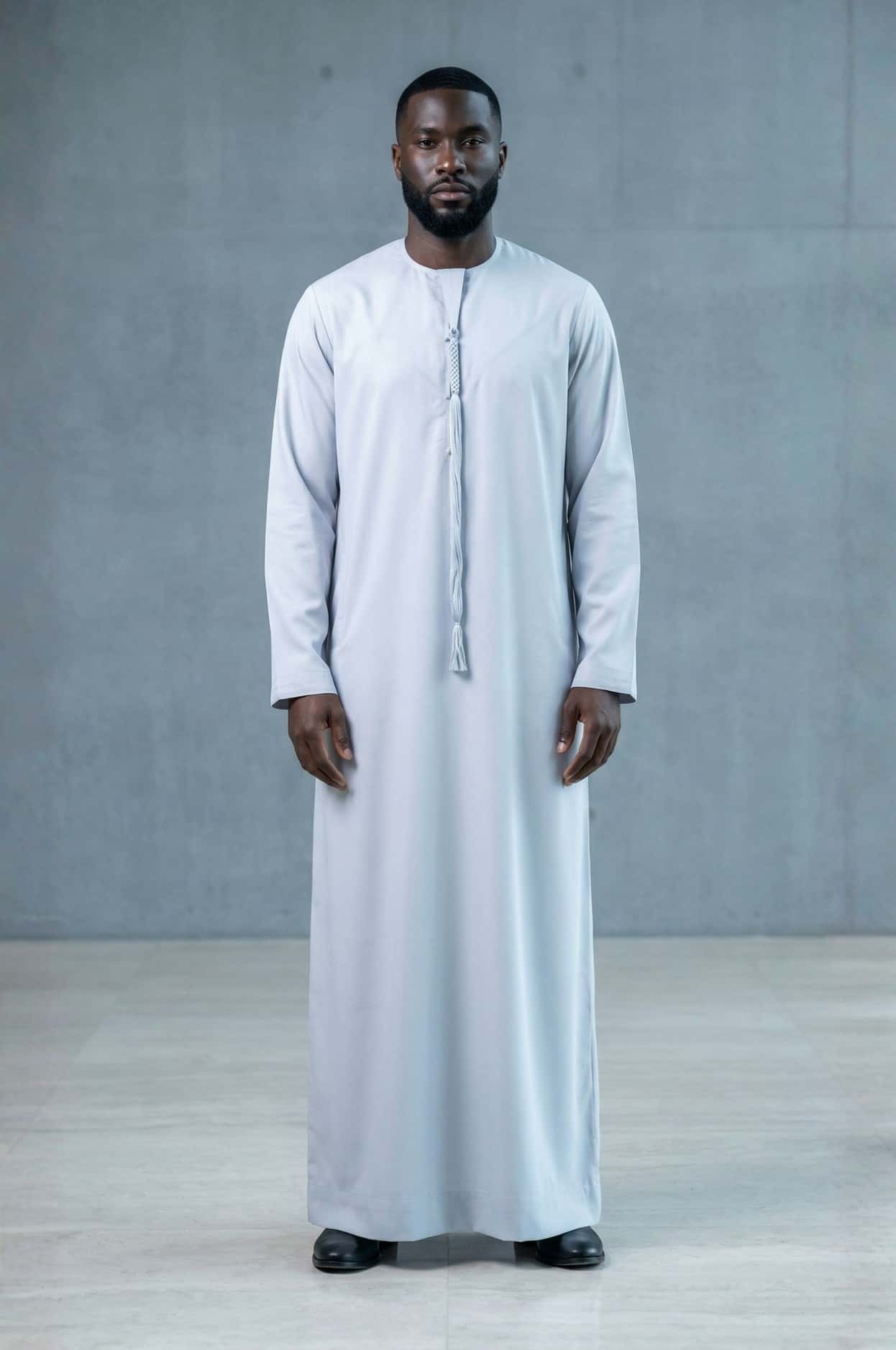 Modern professional wearing an ice grey kandora against Abu Dhabi's contemporary skyline, representing future luxury in traditional dress. 3