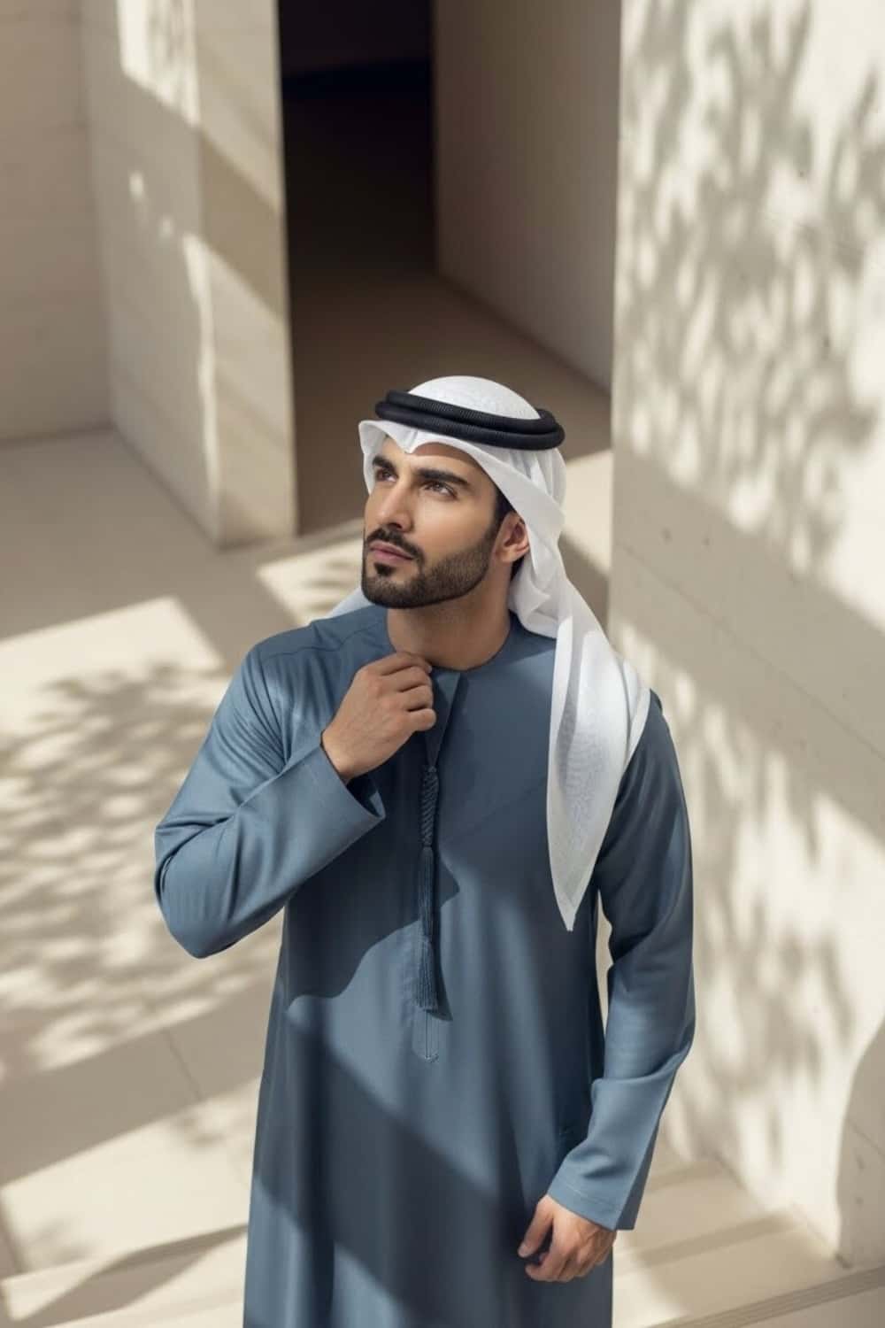 Distinguished man wearing Slate Blue Montgomery Wool Kandora displaying the deep blue tone and refined English wool texture from Shabab al Yola Winter Collection 6