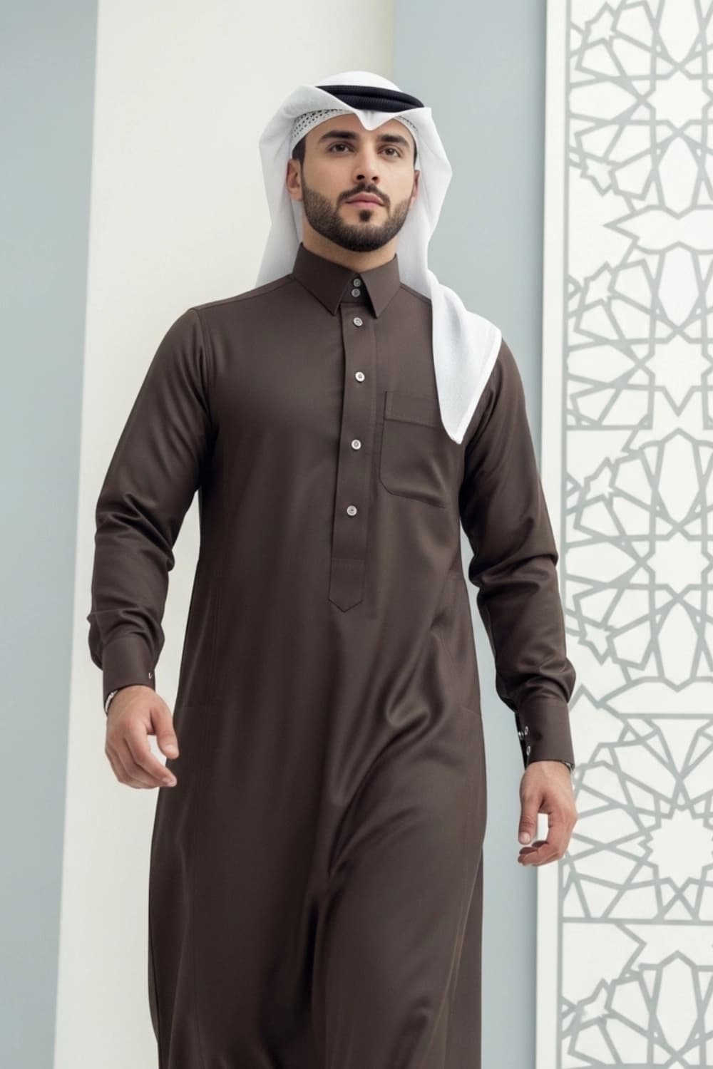 A man wearing the earthy and elegant Brown Qatari Thobe with fine fabric.