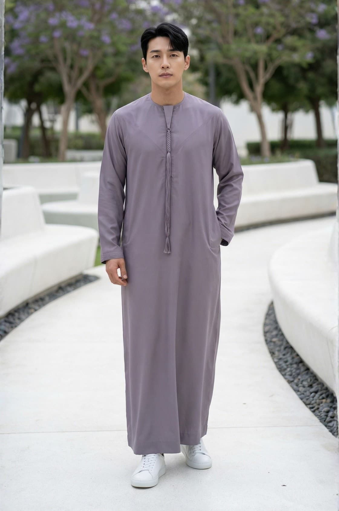 Style-conscious man wearing a unique smoky lavender kandora in Abu Dhabi, showcasing rare color choice in traditional dress. 1