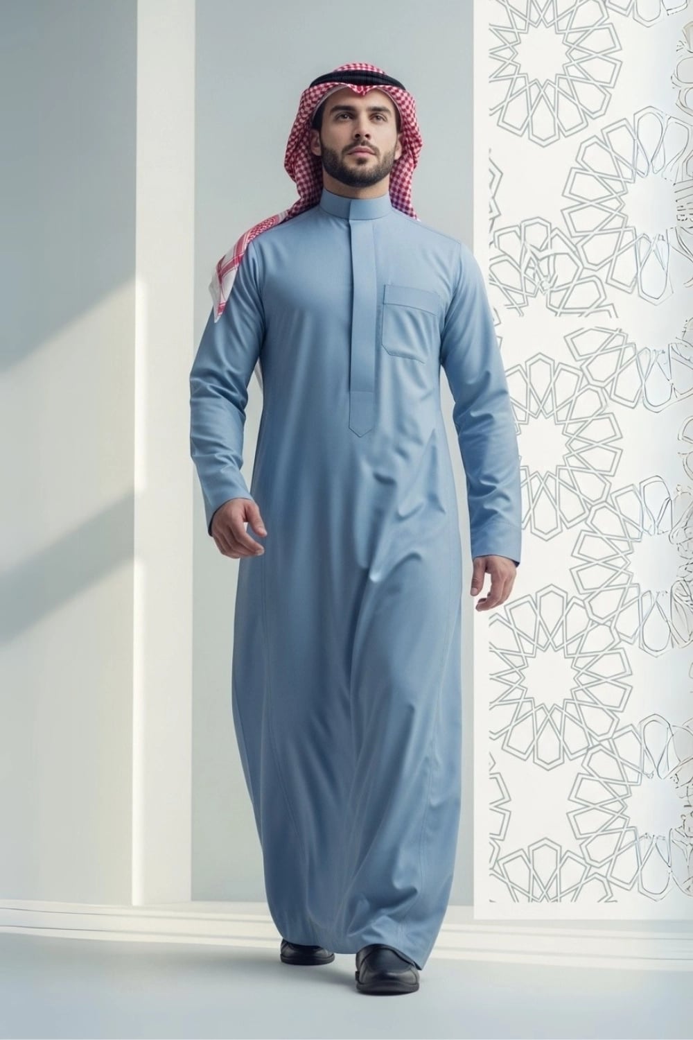 A man wearing the calm and confident Powder Blue Saudi Thobe. 1