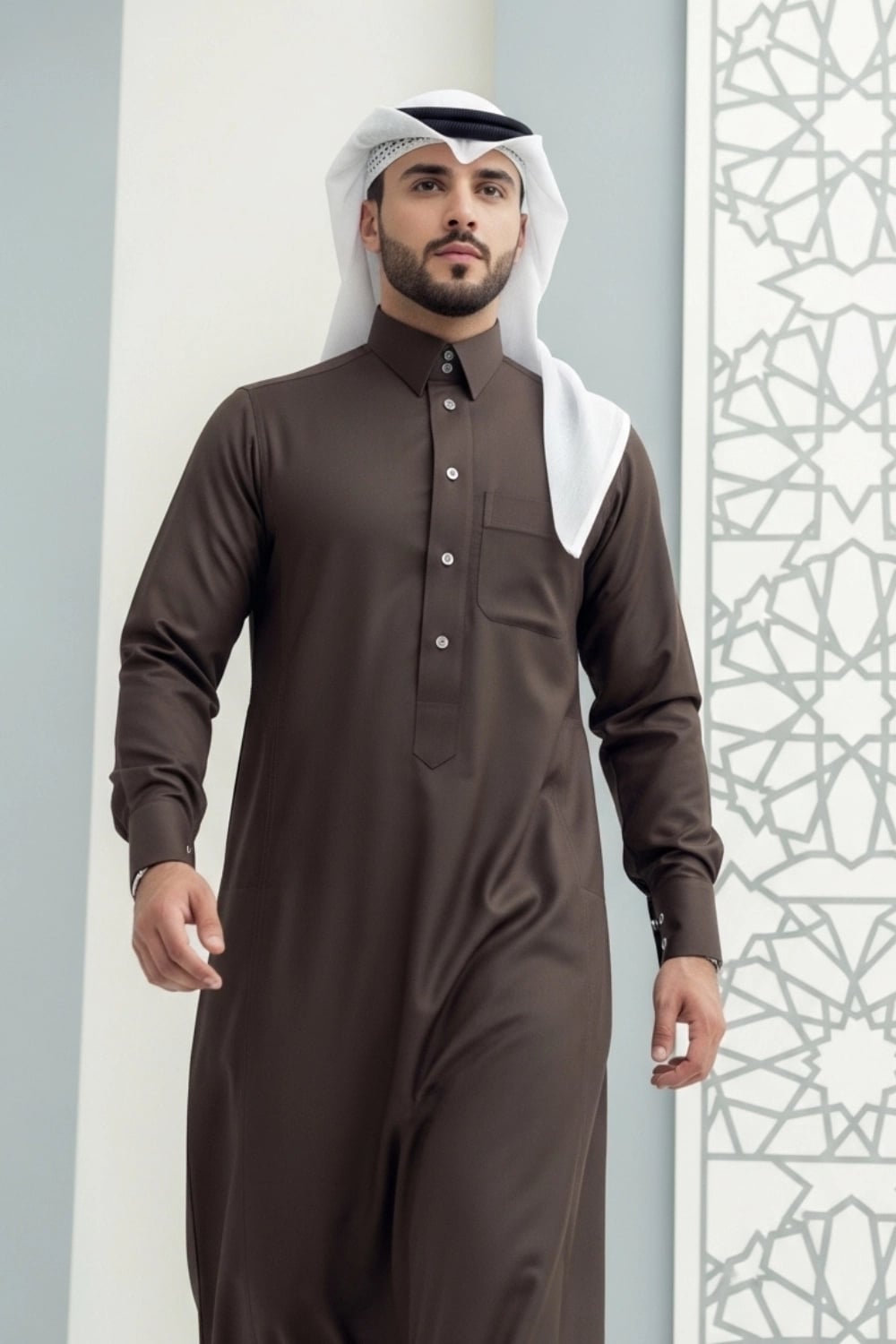 A man wearing the earthy and elegant Brown Qatari Thobe with fine fabric. 1