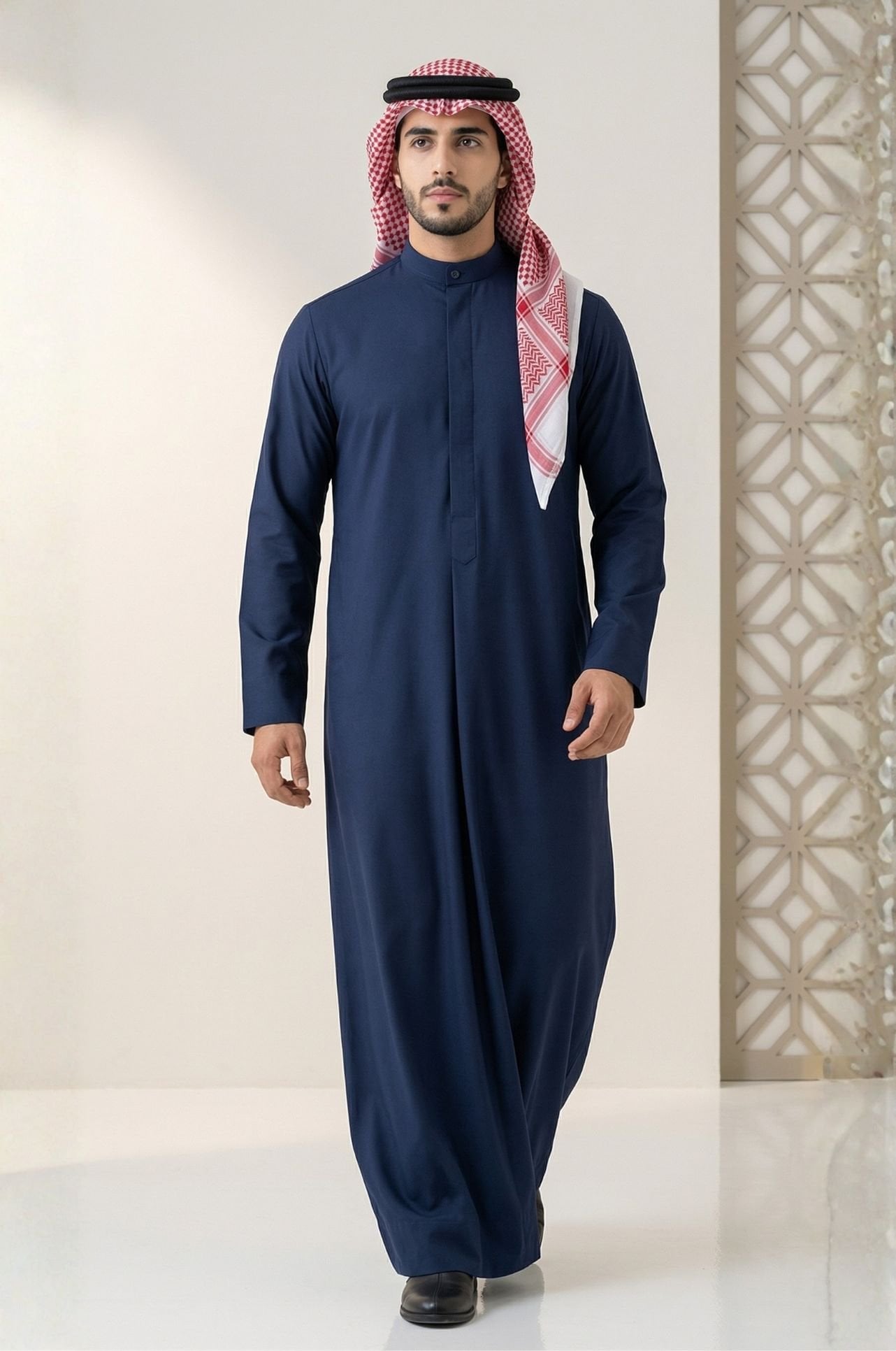 Man in royal navy blue Kuwaiti dishdasha from Shabab al Yola, showing clean lines and premium fabric for winter wear in Abu Dhabi 1