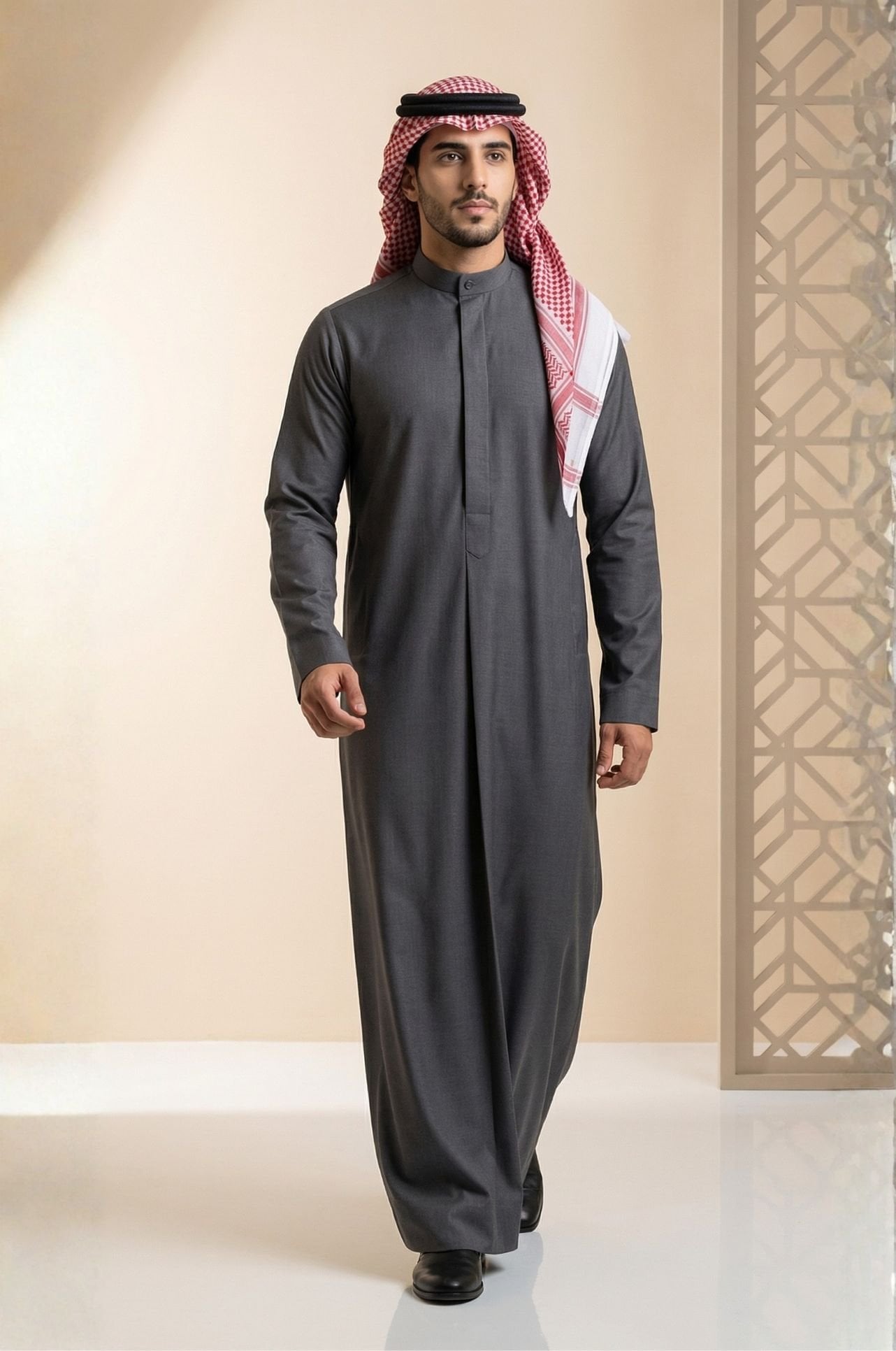 Man wearing charcoal grey Kuwaiti dishdasha by Shabab al Yola, ideal for all-season wear with clean drape in UAE 1