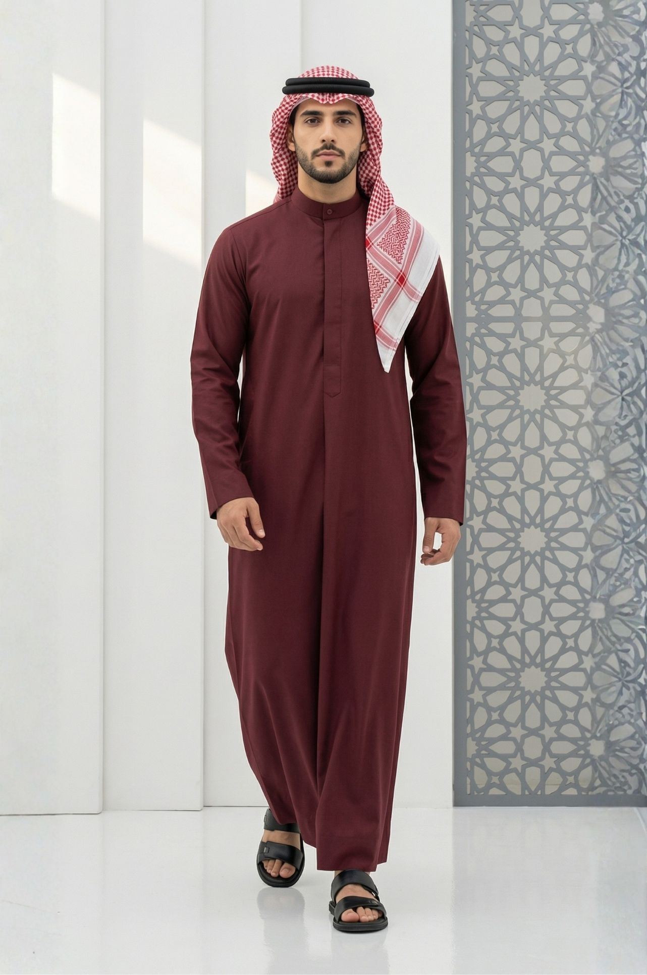 Man in maroon Kuwaiti dishdasha from Shabab al Yola, rich tone for all seasons with comfortable fit in Abu Dhabi 1