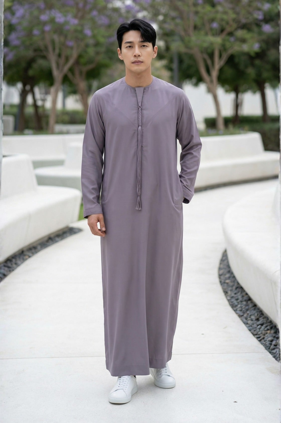 Style-conscious man wearing a unique smoky lavender kandora in Abu Dhabi, showcasing rare color choice in traditional dress. 1